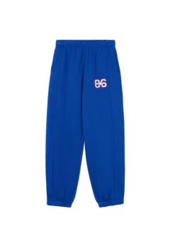 Sale Cropp e dresowe joggery z naszywką niebieski